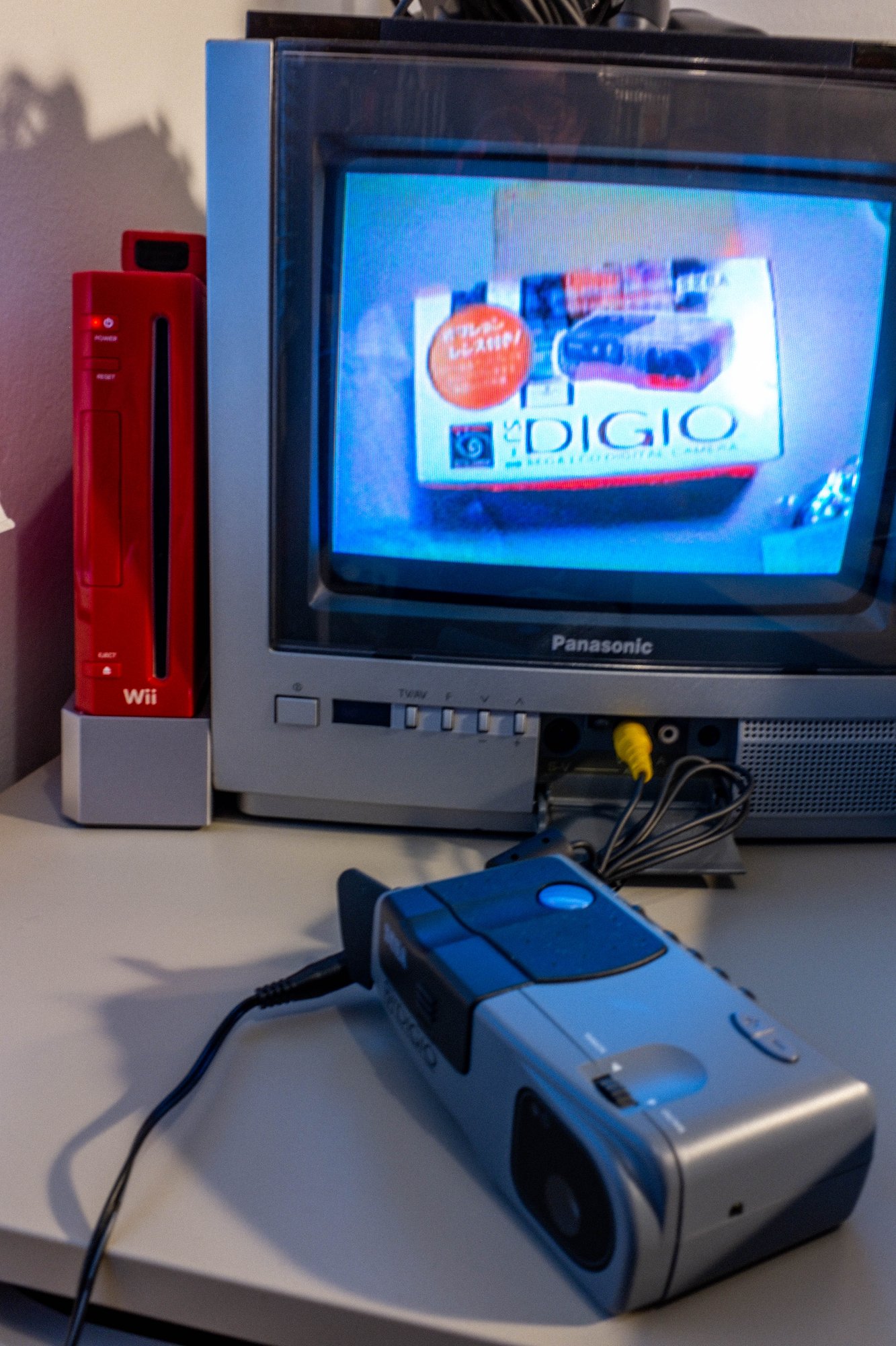 Sega Digio camera connected to a Panasonic CRT television displaying the Digio box.